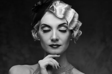 Monochrome portrait of elegant blond retro woman   with beautiful hairdo and little hat