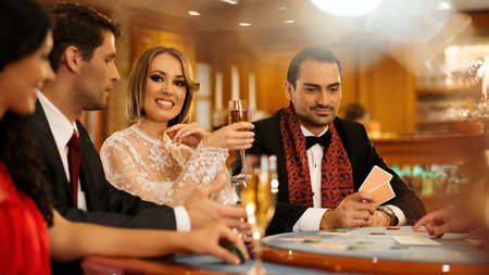 Group of young people playing poker in a casino