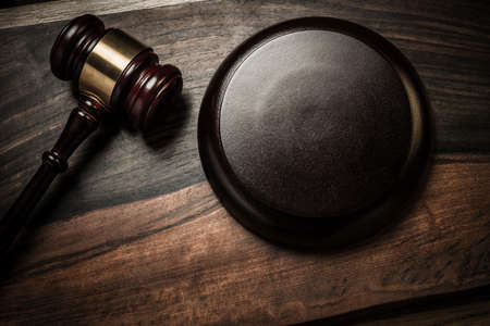 Judge's hammer on wooden table 