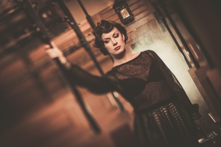 Beautiful vintage style young woman inside retro train coach の写真素材