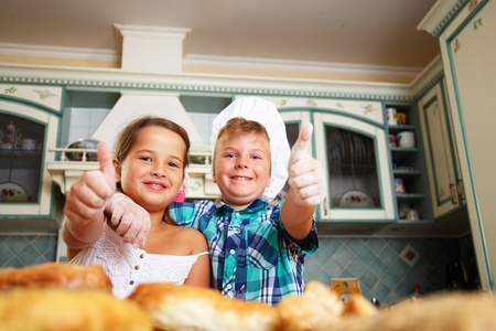 Happy children cooking homemade pastryの写真素材