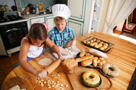 Happy children cooking homemade pastryの写真素材