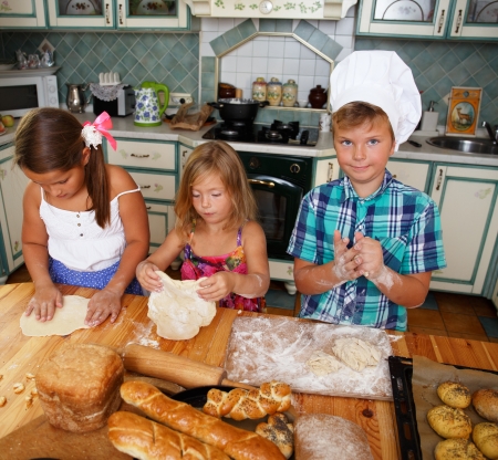 Happy children cooking homemade pastryの写真素材
