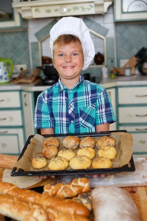 Young cook boy making homemade pastryの写真素材