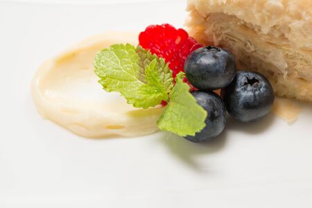 Piece of cake with custard and fruits 