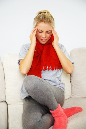 Young blond sick woman with headache の写真素材
