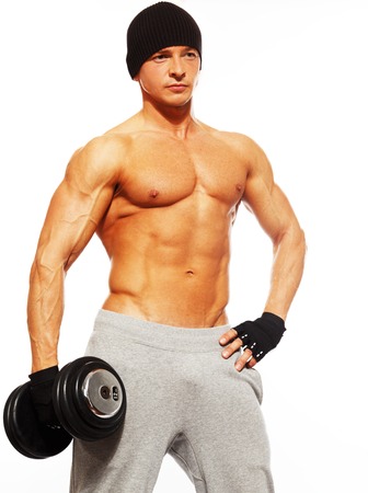 Handsome young muscular man exercising with dumbbellsの写真素材
