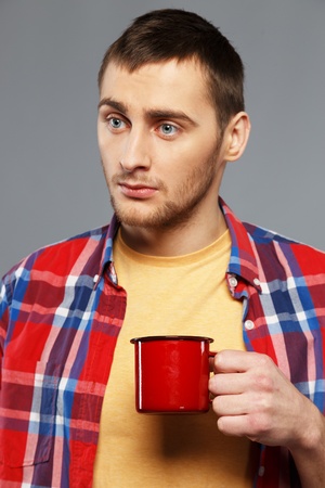 Stylish young man with a metal mug の写真素材