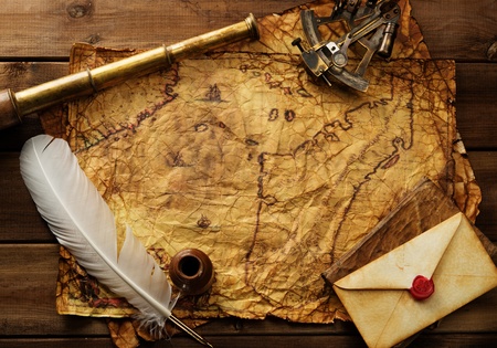Sextant, spyglass and envelope on vintage map over wooden background 
