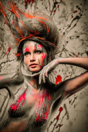 Young woman muse with creative body art and hairdo の写真素材