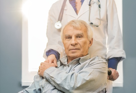Nurse woman with senior man in wheelchair の写真素材
