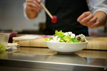 Chief cook preparing salad の写真素材