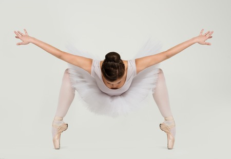 Young ballerina dancer in tutu showing her techniques 