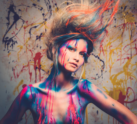 Young woman muse with creative body art and hairdo の写真素材