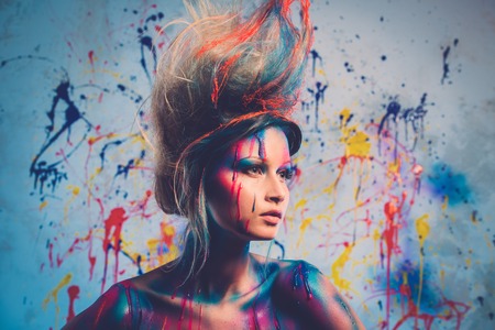 Young woman muse with creative body art and hairdo の写真素材