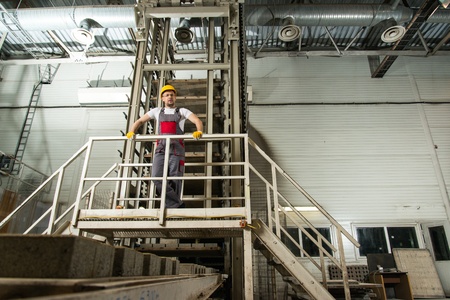 Man in a safety hat on a factory  の写真素材