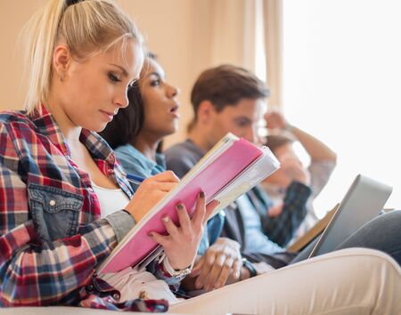 Group of students preparing for exams in apartment interior 