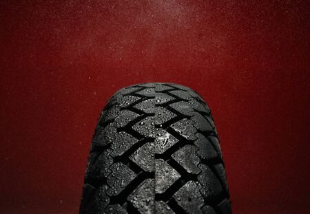 Close-up shot of classical motorcycle tire tread in wet weather condition の写真素材