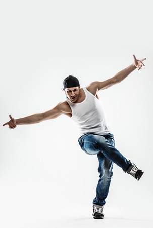 Man dancer showing break-dancing moves isolated on white の写真素材