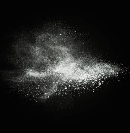 White powder exploding isolated on blackの写真素材