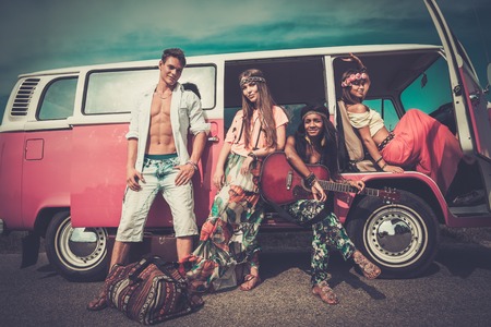 Multi-ethnic hippie friends with guitar on a road tripの写真素材