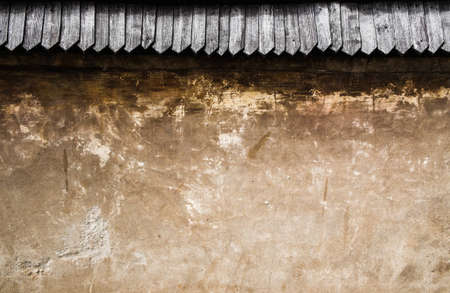 Old stone wall with wooden roof tileの写真素材