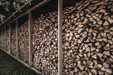 Stockpile of sawed logs under shedの写真素材