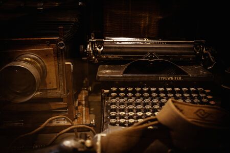 Old camera and typewriter on a tableの写真素材