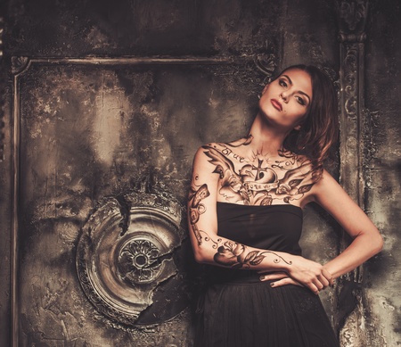 Tattooed beautiful woman in old spooky interiorの写真素材