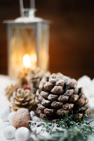 Christmas still life with cones and lantern on a snow の写真素材
