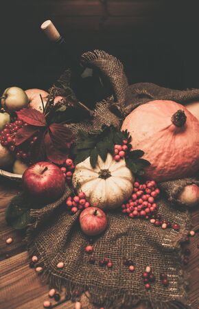 Thanksgiving day autumnal still life with bottle of wine の写真素材