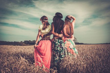 Multi-ethnic hippie girls  in a wheat fieldの写真素材