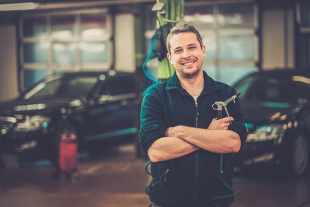 Cheerful man on a car washの写真素材