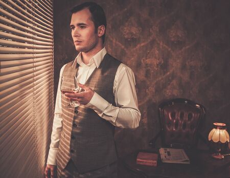 Man with a glass near a windowの写真素材