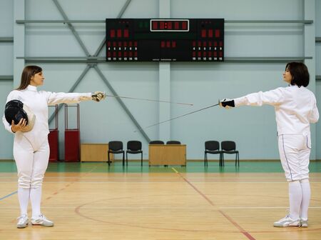 Young woman fencer and her trainerの写真素材