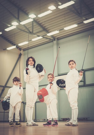 Children fencers and their  trainer