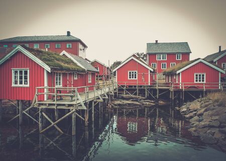 Traditional wooden houses on a water in norwegian villageの写真素材
