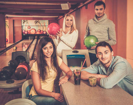 Group of young people behind table in bowling clubの写真素材