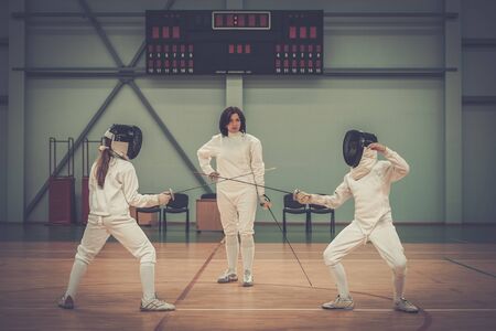 Children fencers and their  trainerの写真素材