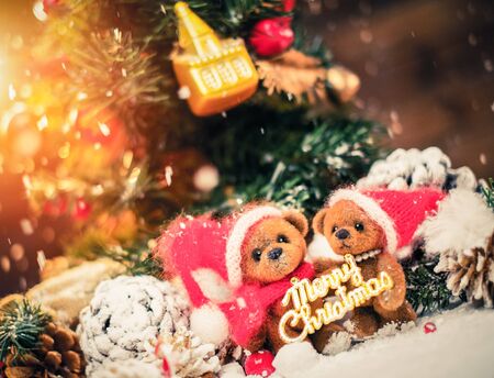 Small toy bears holding Merry Christmas sign in winter holidays still lifeの写真素材