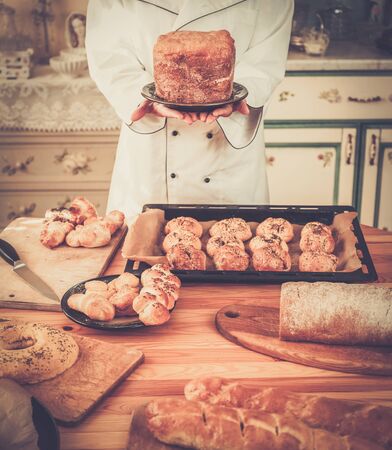 Cook hands holding homemade baked goodsの写真素材