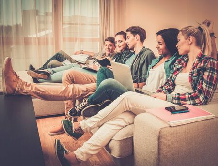 Group of students preparing for exams in apartment interiorの写真素材