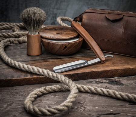 Shaving accessories on a luxury wooden background