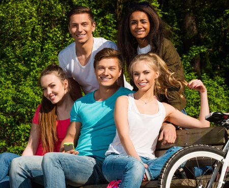 Multi ethnic group of sporty teenage friends in a parkの写真素材