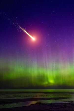 Falling comet and Aurora Borealisの写真素材
