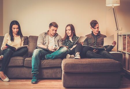 Group of students preparing for exams in apartment interiorの写真素材