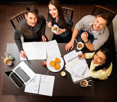 Group of cheerful students preparing for exams