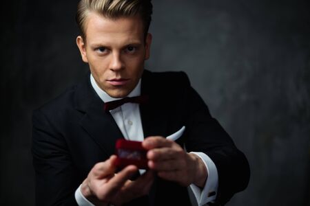 Man holding box with a proposal ringの写真素材