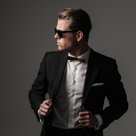 Tough sharp dressed man in black suitの写真素材