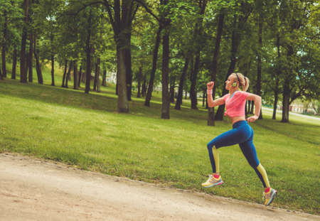Woman running in a parkの写真素材
